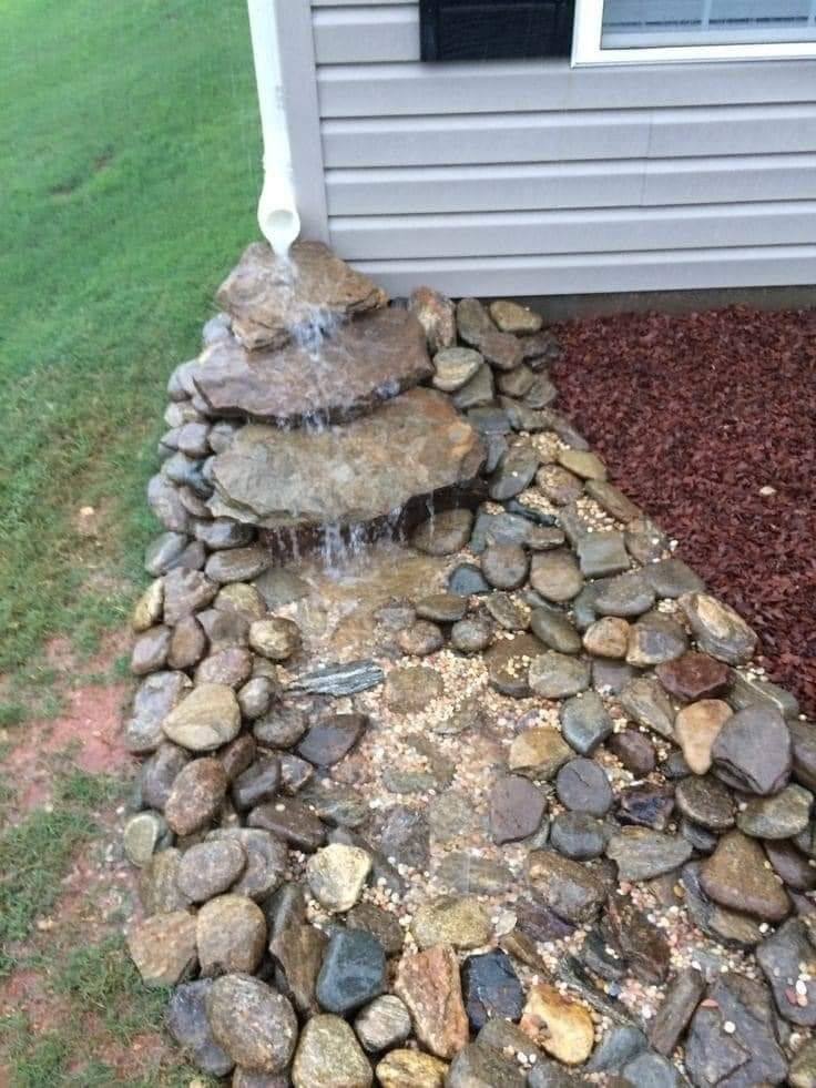 Custom stone waterfall drainage feature